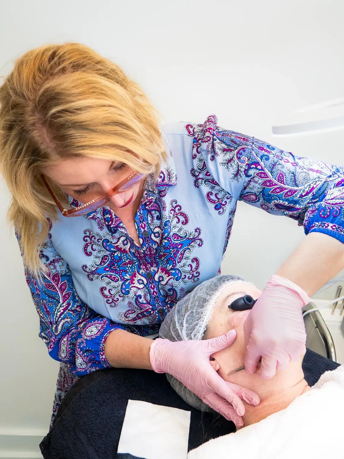 Amy Frances Kimmig-Carey performing dermaplaning treatment
